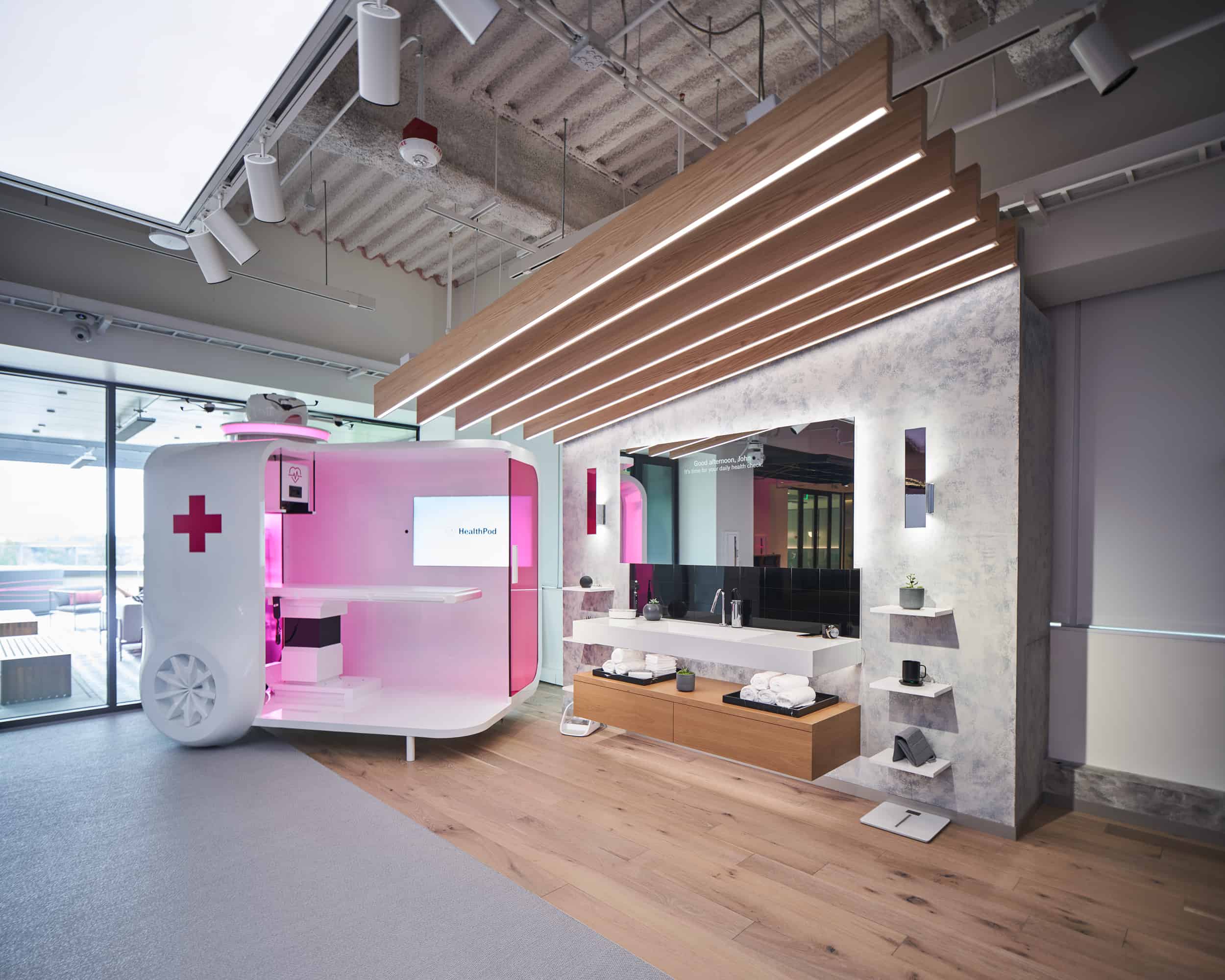 Modern medical room: pink-lit, white case with red cross on left, wood/marble textures, towel shelves, sleek sink, ceiling lights.