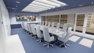 Amplia sala de reuniones con una mesa alargada situada frente a dos pantallas digitales montadas en la pared