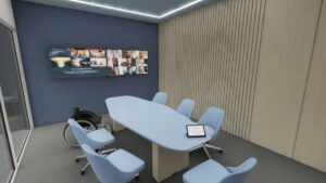 Pequeña sala de reuniones con dos pantallas montadas en la pared, una mesa de reuniones, asientos y una silla de ruedas.